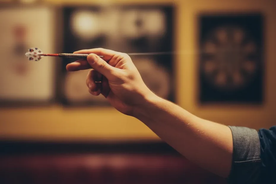 Gabby Partington smiling and holding a microphone, ready to host a darts event